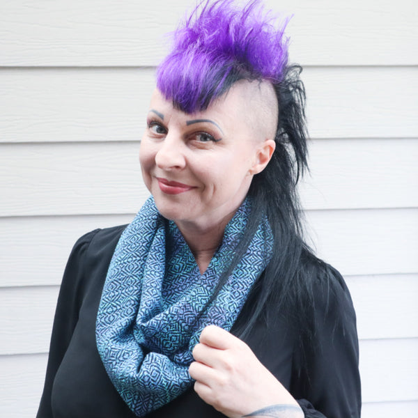 girl with purple and black mohawk wearing blue handwoven scarf